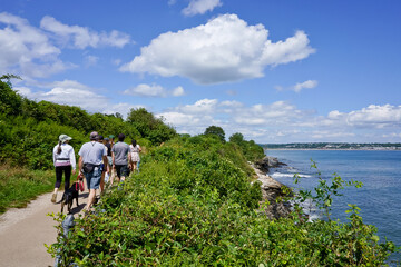 Hikers walking on Cliff Walk trail Newport RI USA