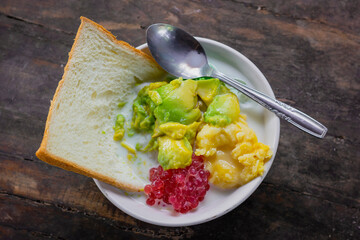 Es campur teler or called mix ice from Indonesia, made from alpukat (avocado), kelapa muda (young coconut meat), bread, pearl sagu, cassava tape, sticky rice tape, and milk. 