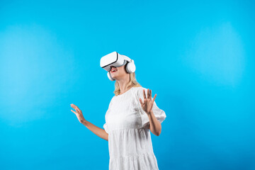 Skilled girl in pajamas excited with metaverse by using VR goggle at background. Caucasian woman...