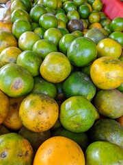 Fresh orange fruit in a basket on the market. Close up detail of  fresh orange fruit