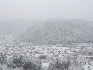 JAPAN : Aerial view of North East area of Japan in December winter season. View of snow covered land. Houses, street and road covered with heavy snow. Winter travel and journey concept shot