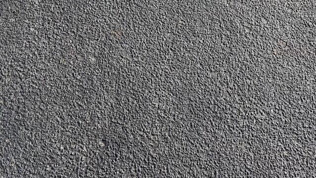 A solid, gray expanse underfoot, the concrete sidewalk runs straight and smooth, offering a sturdy path amidst the urban landscape.