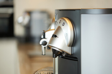 Close-up of modern espresso machine in a kitchen setting