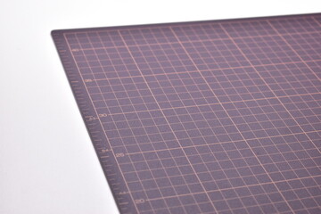black cutting mat board on white background with line and scale measure guide pattern for object...