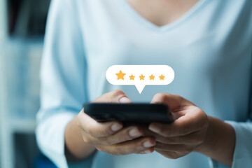 customer satisfaction survey concept businesswoman use smartphone Touch the happy smiley icon. Satisfied. 5 stars. Service experience rating. online application Satisfaction Review best quality..