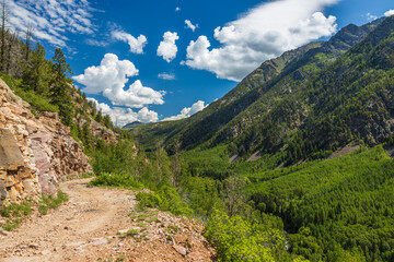 summer mountain valley with old dirt road