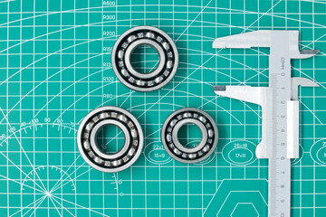 Measure caliper and roller bearings on cutting mat