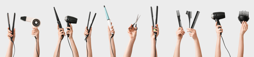 Many hands with hairdresser's supplies on grey background