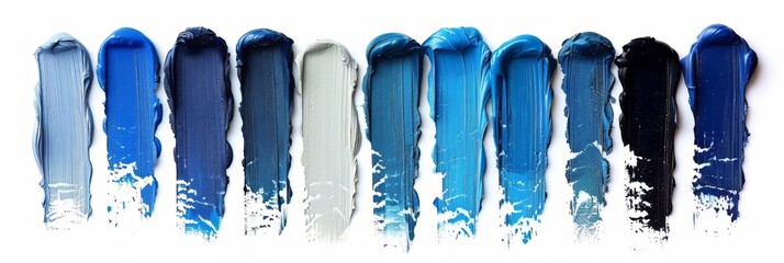 A set of blue color paint strokes isolated on a white background, viewed from the top, serving as blue shades swatches for makeup, cosmetic product, or beauty industry concept.