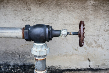 Rusty Industrial Water Pump and Tap on Wall