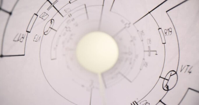 Sheet of paper with technical drawings twisted in roll