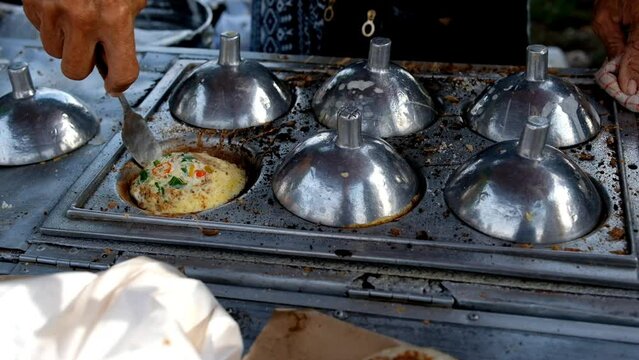 Footage of making a typical Indonesian pancake called Serabi. Serabi is made from coconut dough filled with savory toppings. Indonesian Gourmet. Food and Culinary. 4K 30 Fps Videos