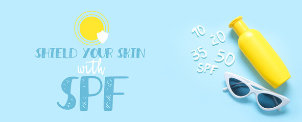 Word SPF with numbers made of sunscreen cream and sunglasses on blue background