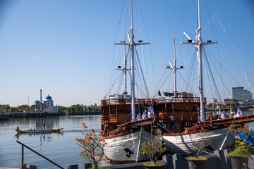 Phinisi wooden boats anchor at Losari Beach. Famous traditional boat from Makassar, South Sulawesi,...