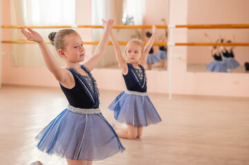 Little ballerinas perform at a dance school. 