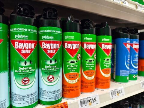 Array of Baygon insect killer sprays on store shelf focusing on pest control and safety
