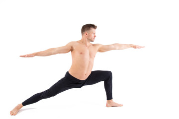 Sports and healthy lifestyle. An attractive man is doing Pilates. White background.