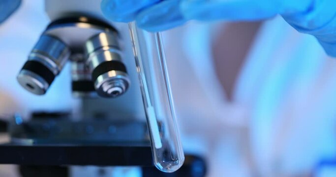 Researcher makes smear inside test tube using applicator