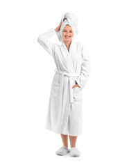 Young woman in bathrobe after shower on white background