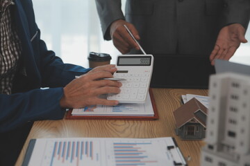 balancing the property sector The real estate agent is explaining the house style to see the house...