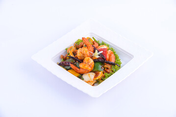 Sweet and sour shimp stir fried on the white dish.