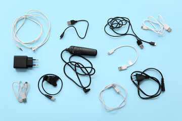 Composition with different USB cables on color background