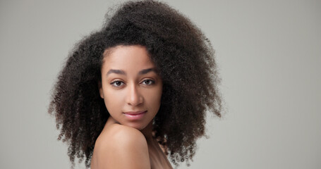 Beauty and Healthcare concept - Beautiful African American woman with curly afro hairstyle hair and...