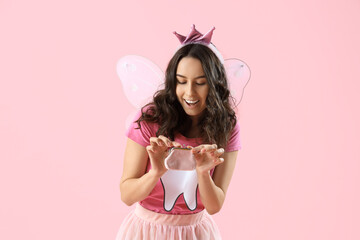 Tooth Fairy with wallet on pink background