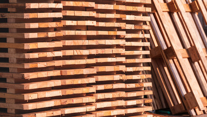 Stack of many small square wood bases are made from the old wooden pallets, recycling and reuse remaining wooden material used concept 