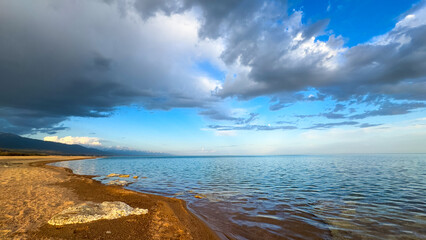 Sunny summer day on the lake. Mountains and sea. Kyrgyzstan, Lake Issyk-Kul