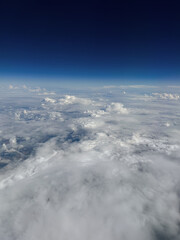 Aerial view of clouds and blue sky. Shot in flight. Toronto, Canada.