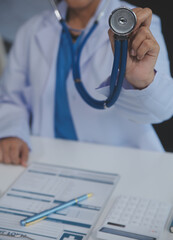 Close-up of female doctor using stethoscope , focus on stethoscope