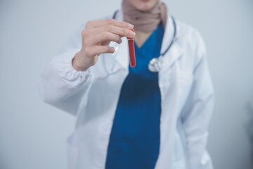 Technician, doctor, scientist in laboratory with blood sample tubes and rack In the laboratory holding a blood vessel sample for study, experiment, medical research biotechnology DNA testing.