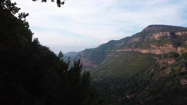 Scenic view of Sant Miquel del Fai in Barcelona with lush greenery and towering cliffs