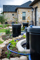 Obraz premium Builder installs rainwater harvesting system, water conservation and sustainable construction practices.