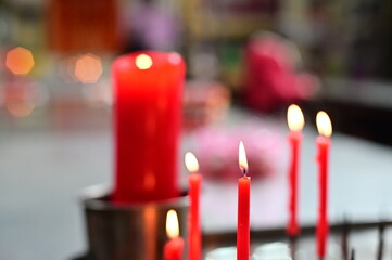 Red candles in Taiwanese temples signify worshippers' respect and requests to deities, embodying...