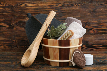 Set of different supplies for sauna on wooden background