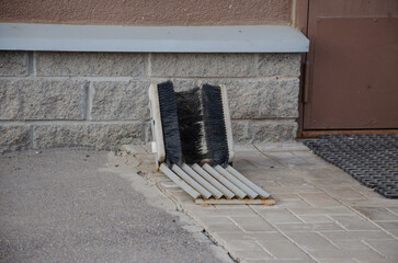 shoe brushes in front of the house on the street