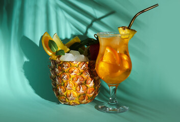 Delicious summer cocktails and palm leaf shadow on color background