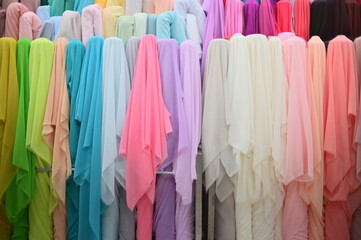 Close-up of colorful fabrics at a wholesale and retail fabric market.