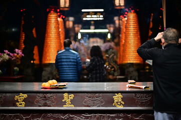 Taiwan - Feb 01, 2024: Devotees holding incense sticks and praying at Cisheng Temple (慈聖宮)....