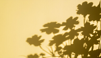 Natural flower shadows are blurred on light yellow color wall at home at sunrise. Summer beach with minimal concept.