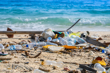 trash, plastic cups and plastic bags at the beach. environmental problem concept and healing the...