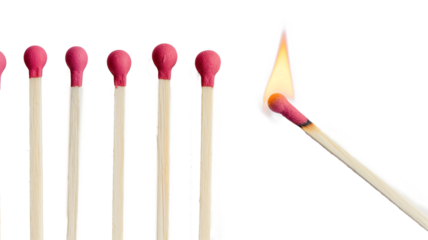 Lit match next to a row of unlit matches isolated on a transparent background