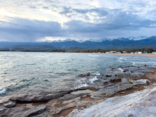 Sunny summer day on the lake. Mountains and sea. Kyrgyzstan, Lake Issyk-Kul