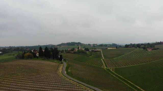 drone flights straight over the gavi hills full of vineyards during a spring day