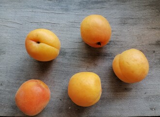 Apricots on the old wood table. Sweet summer food