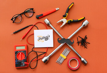 Paper mustache, tools and greeting card with text HAPPY FATHER'S DAY on orange background