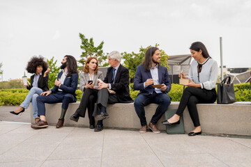 Diverse Corporate Team Engaging in Casual Outdoor Meeting