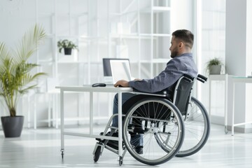 Handsome businessman in wheelchair in office